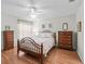 Cozy bedroom offers natural light, wood-look floors, and neutral walls creating a calming space at 3183 Hatch Ln, The Villages, FL 32162