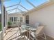 Outdoor patio featuring tile flooring, a glass table, and a bright, sunny atmosphere at 3183 Hatch Ln, The Villages, FL 32162