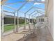 Covered patio with tiled floor, seating, and a view of the landscaped backyard at 3183 Hatch Ln, The Villages, FL 32162