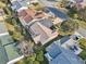 Aerial view of the property features a screen enclosed patio and landscaping, nestled within a well-maintained neighborhood at 3319 Thorncrest Dr, The Villages, FL 32162