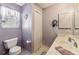 Charming bathroom with a toilet, vanity, and window with natural light at 3319 Thorncrest Dr, The Villages, FL 32162