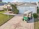 Inviting home featuring a decorative driveway, two-car garage, and well-maintained landscaping at 3319 Thorncrest Dr, The Villages, FL 32162