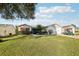 Inviting single-story home features a well-manicured lawn, mature landscaping, and a two-car garage at 3319 Thorncrest Dr, The Villages, FL 32162