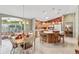 Kitchen and dining area with tile floor, breakfast bar, and ample cabinet space at 3319 Thorncrest Dr, The Villages, FL 32162