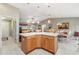 Spacious kitchen island with wood cabinets, white countertop, and pendant lighting at 3319 Thorncrest Dr, The Villages, FL 32162