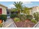 Professionally landscaped front yard with shrubbery and rock gardens leading to the home's screened-in porch at 3319 Thorncrest Dr, The Villages, FL 32162