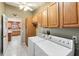 A practical laundry area with ample cabinet space and a modern washer and dryer set at 3319 Thorncrest Dr, The Villages, FL 32162