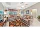 Cozy living room with tile floors, neutral walls, ceiling fan and leather seating at 3319 Thorncrest Dr, The Villages, FL 32162