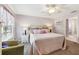 Inviting bedroom with a bed, side tables, and a cozy chair at 3319 Thorncrest Dr, The Villages, FL 32162