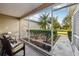 A screened-in porch with wicker seating provides a relaxing outdoor space, with lush landscaping outside at 3319 Thorncrest Dr, The Villages, FL 32162