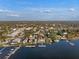 Vibrant aerial image showing waterfront homes with private docks and stunning water views at 343 N Mcdonald St # 203, Mount Dora, FL 32757