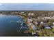 Aerial view of waterfront community with docks and boat slips, homes nestled among mature trees at 343 N Mcdonald St # 203, Mount Dora, FL 32757