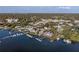 Aerial view of a lakefront home and community with a private dock along the shoreline at 343 N Mcdonald St # 203, Mount Dora, FL 32757