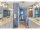 Bathroom featuring double sinks, white cabinets and tile, a glass enclosed shower, and a neutral color scheme at 343 N Mcdonald St # 203, Mount Dora, FL 32757