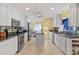 Well-lit kitchen features stainless steel appliances, dark granite countertops, and custom white cabinetry at 343 N Mcdonald St # 203, Mount Dora, FL 32757