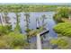 Picturesque aerial view of a pier stretching across a tranquil lake surrounded by lush greenery at 3480 Soho St # 206, Orlando, FL 32835