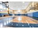 Bright basketball court with multiple hoops and natural light coming through many windows at 3480 Soho St # 206, Orlando, FL 32835