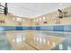 Spacious indoor basketball court with multiple hoops and a polished wooden floor at 3480 Soho St # 206, Orlando, FL 32835