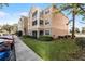 Charming condo exterior with balconies, sidewalk and lush green lawn in a well-maintained community at 3480 Soho St # 206, Orlando, FL 32835