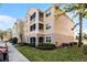 Attractive condo exterior with balconies, lush lawn and green shrubs in a well-maintained community at 3480 Soho St # 206, Orlando, FL 32835