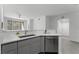 Modern kitchen with gray cabinetry, stainless steel dishwasher, and sleek countertops at 3480 Soho St # 206, Orlando, FL 32835