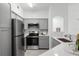 Modern kitchen featuring gray cabinets, stainless steel appliances, and sleek countertops at 3480 Soho St # 206, Orlando, FL 32835