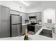 Modern kitchen with gray cabinets, stainless steel appliances and elegant countertop at 3480 Soho St # 206, Orlando, FL 32835