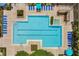 Top-down view of the community pool and hot tub, surrounded by ample lounge seating and well-maintained landscaping at 3480 Soho St # 206, Orlando, FL 32835