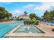 Community pool with ample deck and lounge chairs and a jacuzzi; perfect for relaxation and recreation at 3480 Soho St # 206, Orlando, FL 32835