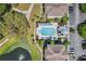 Aerial view of the community pool surrounded by lush greenery and trees with plenty of parking spaces at 3480 Soho St # 206, Orlando, FL 32835