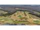 Aerial view of a golf course with winding cart paths at 3769 Causey Ct, The Villages, FL 32163