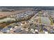 Aerial view of houses and a lake in a residential area at 3769 Causey Ct, The Villages, FL 32163