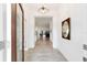 Bright and airy entryway with tile flooring and modern light fixture at 3769 Causey Ct, The Villages, FL 32163