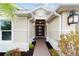 Front entry with a modern door and walkway at 3769 Causey Ct, The Villages, FL 32163