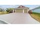 House front with driveway and landscaping at 3769 Causey Ct, The Villages, FL 32163