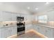 Modern kitchen with white cabinets and geometric backsplash at 3769 Causey Ct, The Villages, FL 32163