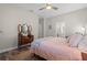 Bright bedroom with a queen bed, dresser, and ensuite bathroom access at 4127 Arlington Ridge Blvd, Leesburg, FL 34748