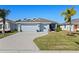 Single-story home with two-car garage and landscaped lawn at 4127 Arlington Ridge Blvd, Leesburg, FL 34748