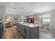 Open kitchen features a large island, gray cabinets, and white countertops at 4127 Arlington Ridge Blvd, Leesburg, FL 34748