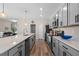 Modern kitchen with gray cabinets, quartz countertops, and stainless steel appliances at 4127 Arlington Ridge Blvd, Leesburg, FL 34748