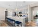 Modern kitchen with gray cabinets and island with seating at 4127 Arlington Ridge Blvd, Leesburg, FL 34748