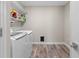 Laundry room with washer, dryer, and ample storage shelving at 4127 Arlington Ridge Blvd, Leesburg, FL 34748