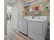 Bright laundry room with washer, dryer, and ample shelving at 4127 Arlington Ridge Blvd, Leesburg, FL 34748