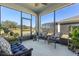 Relaxing screened porch with wicker furniture at 4127 Arlington Ridge Blvd, Leesburg, FL 34748