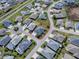 Aerial view of a single-Gathering home in a residential neighborhood with a well manicured lawn at 4774 Cosentino Ct, The Villages, FL 32163