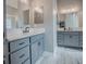 This bathroom has double vanities with framed mirrors and modern hardware at 4774 Cosentino Ct, The Villages, FL 32163