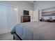 Well-lit bedroom featuring a large bed, dresser, and closet at 4774 Cosentino Ct, The Villages, FL 32163