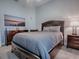 This bedroom features a large bed with a padded headboard and a view of the water at 4774 Cosentino Ct, The Villages, FL 32163