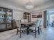 Elegant dining room with wood-look tile flooring and display cabinets at 4774 Cosentino Ct, The Villages, FL 32163