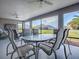 This screened lanai offers multiple seating options and a view of the back yard at 4774 Cosentino Ct, The Villages, FL 32163